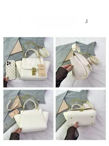 Detailed views of a white crocodile pattern handbag with gold hardware and chain strap