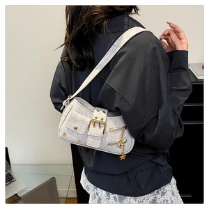 Detail of off-white shoulder bag with star chain and metal buckles on striped blazer