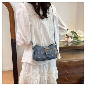 Blue denim texture heart pattern bag with star rivets and gold hardware on model