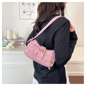 Pink star charm shoulder bag detail with metal studs and motorcycle style buckles