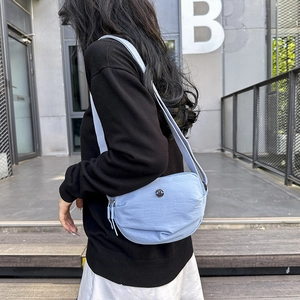Light blue nylon crescent crossbody bag for men and women in a casual street style