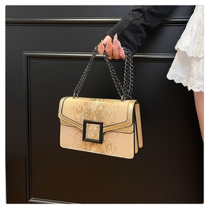 Detailed macro view of snakeskin embossed texture with black chain and square buckle