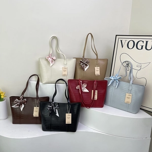Multicolor crocodile pattern tote bags with silk scarves shown from a frontal perspective
