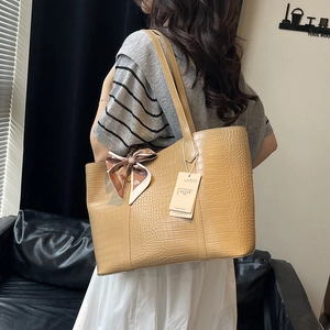 Khaki crocodile pattern large tote bag with silk scarf on a model for daily use