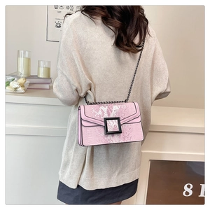 Detail of pink python print crossbody bag with black chain strap and square buckle
