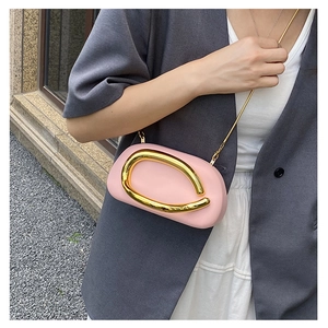 Pink oval evening clutch bag with gold U-shaped metal buckle and delicate chain strap