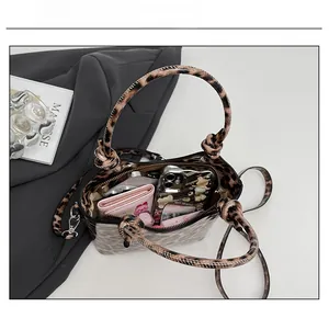 Internal view of leopard print bucket bag showing capacity for phone and essentials