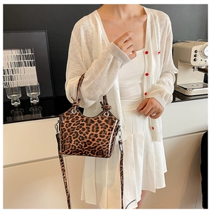 Detail of leopard print bucket bag with knotted handle and glossy patent leather finish