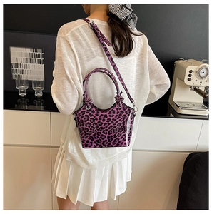 Detail of purple leopard print bucket bag with glossy texture and knotted handle style