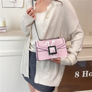 Pink snakeskin pattern shoulder bag with a black chain strap and metal buckle