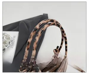 Close-up of the stylish knotted handle on the leopard print bucket bag for women