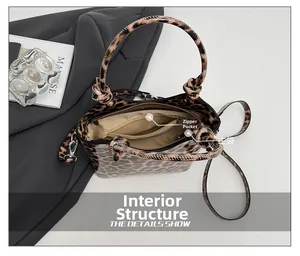 Detailed interior of leopard print bucket bag featuring a zipper pocket and main compartment