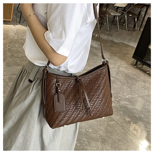 Deep brown woven leather shoulder bag for women with cross-braided design and slim strap