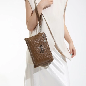 Brown woven texture handbag with dual zipper compartments and metallic bow charm