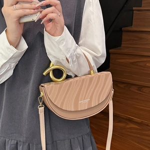 Chic beige saddle bag with wave-embossed leather and golden knot hardware detail