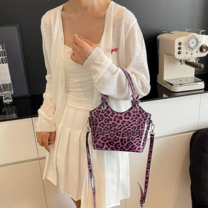 Purple leopard print crossbody bucket bag with glossy patent leather finish and top handle