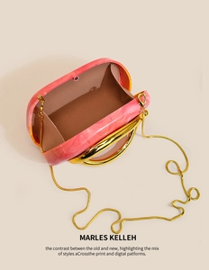 Detailed view of pink marble acrylic evening clutch with gold ring handle and snake chain