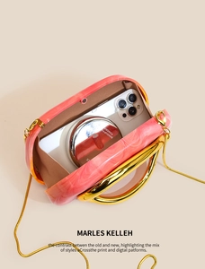 Pink marble acrylic evening bag with gold ring handle and snake chain strap detail