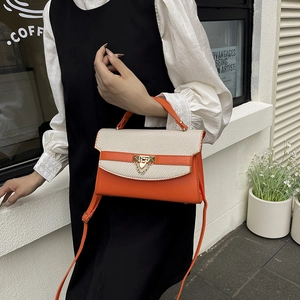 Chic orange and beige woven textured Kelly bag with golden buckle and chain details