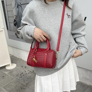 Red woven leather Boston bag featuring a classic handle and detachable shoulder strap
