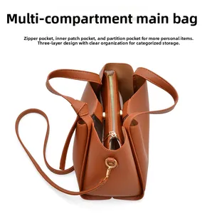 Brown leather tote bag featuring a triple compartment interior and golden hardware