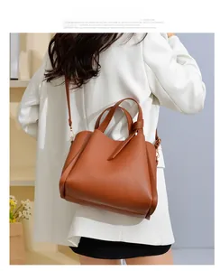 Detailed view of brown lychee texture bucket bag with adjustable shoulder strap