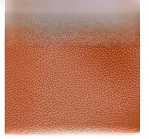Macro shot of premium caramel brown pebble-grain leather texture with durable finish