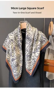 Detail of 90cm silk-textured floral scarf styled as a shawl on a black dress display