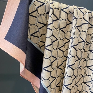 Navy and pink geometric V-pattern silk scarf with striped border and elegant drape