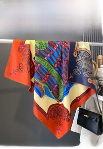 Detailed view of elegant double-sided printed silk scarf with vibrant geometric patterns
