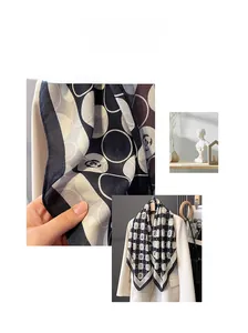 Detail shot of a polka dot camellia silk scarf showing twill texture and geometric patterns