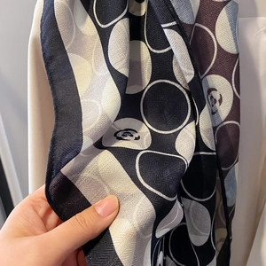 Silk square scarf featuring camellia and polka dot patterns in classic black and white tones