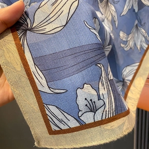 Blue floral silk scarf with herringbone texture shown in close-up detail for women