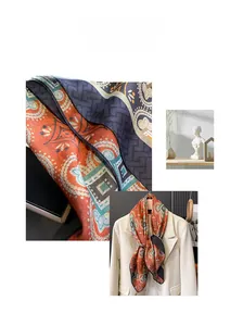 Detail of paisley silk scarf with orange and teal patterns on white suit lapel