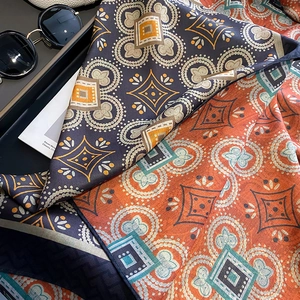 Navy and orange silk scarf with geometric mandala pattern and elegant satin texture