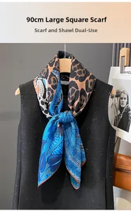 Close-up of 90cm leopard and blue feather print silk scarf styled on a black sequin vest