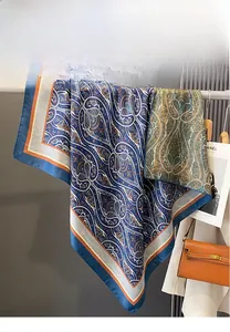 Detail of double-sided paisley print scarf showing silky texture and elegant draping
