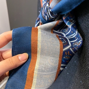 Geometric paisley pattern scarf with herringbone weave in navy and orange tones