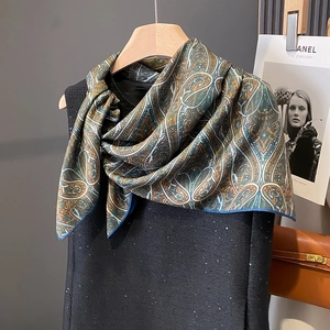 Retro paisley print silk scarf with emerald and navy tones on tweed dress
