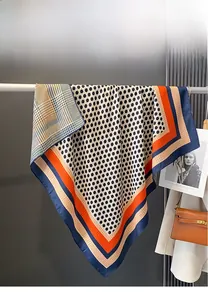 Detailed close-up of double-sided polka dot and grid pattern scarf with contrast borders