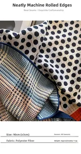 Close-up of a 90cm polka dot polyester scarf showing machine hemmed edges and texture