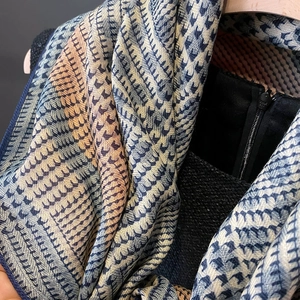 Detail of blue and orange gradient pashmina with intricate herringbone weave and fringe edge