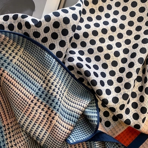 Polka dot and geometric pattern scarf with navy blue edge and mixed print textures