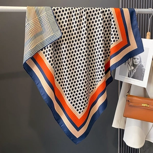 Elegant polka dot scarf with navy patterns and vibrant borders on high-quality silk fabric
