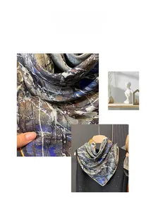Detailed close-up of retro abstract silk scarf with navy blue and mustard yellow patterns
