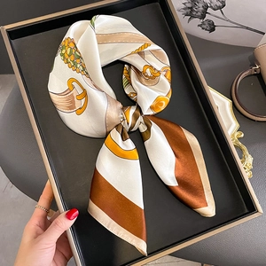 Elegant silk scarf with chain print and geometric patterns in white, brown and orange