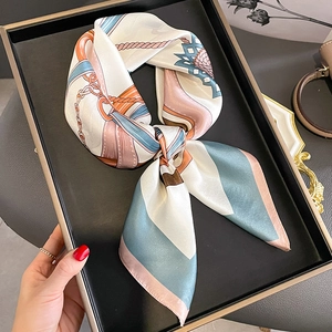 Elegant silk square scarf with geometric chain print on a premium tray