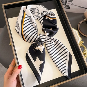 Chic silk-feel square scarf with houndstooth and geometric patterns tied in a bow