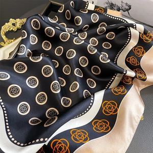 Satin silk scarf featuring orange camellia flower patterns and a geometric border