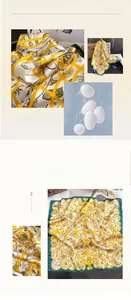 Detail of 100% mulberry silk scarf featuring yellow floral patterns and green borders